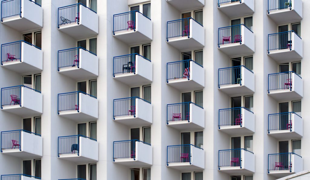 White abstract background of a modern apartment building with balconies