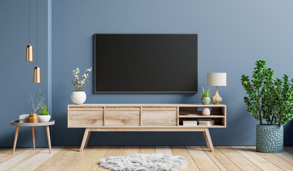 Living room with TV, TV stand and plants