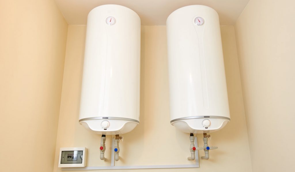 Two electric water heaters on the wall.