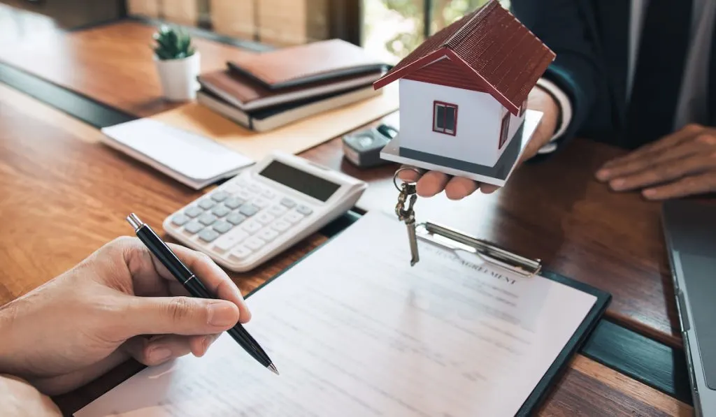 customer signing on contract paper for renting new apartment concept 