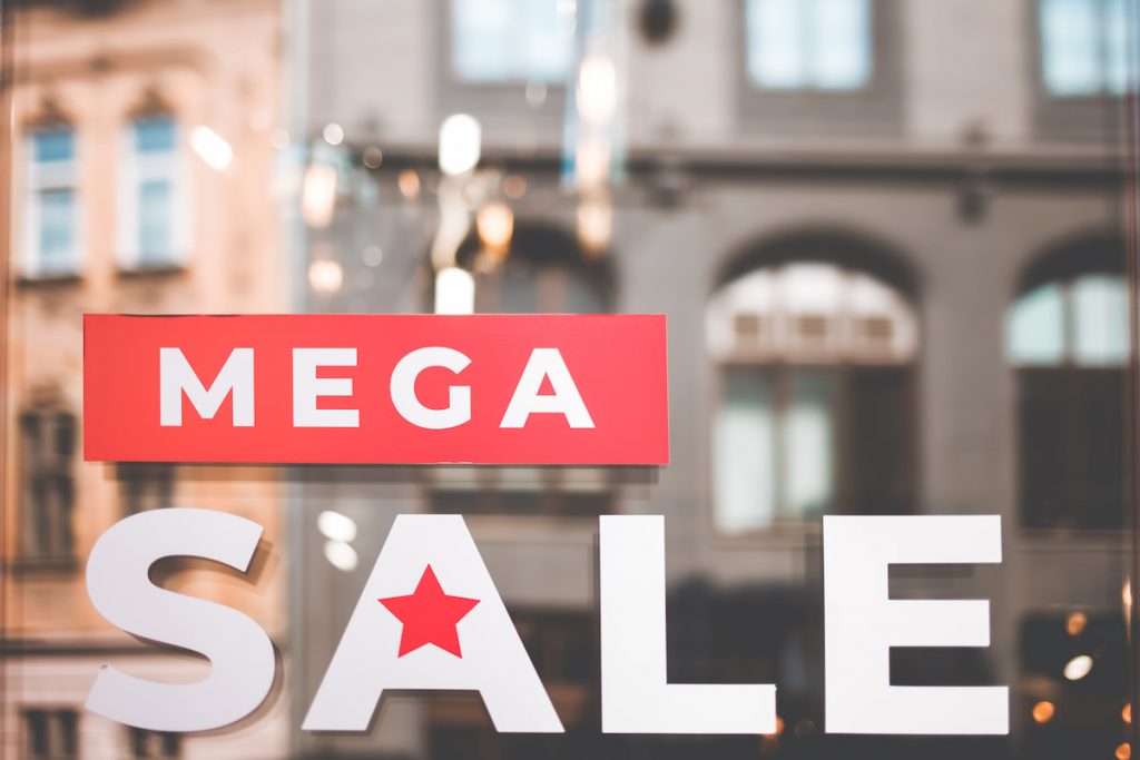 inscription mega sale on shop windows. Mega sale sign in store
