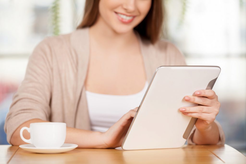 woman using a tablet connected to home wifi
